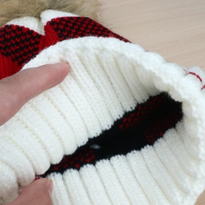 Women's warm winter beanie hat with faux fur pom pom and red black plaid knit pattern