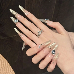 Press-on nails with champagne gold cat-eye glitter, blue rhinestones, and pearls