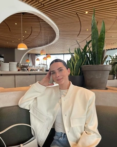 Modern cream white bomber jacket with stand collar and large front pockets lifestyle view