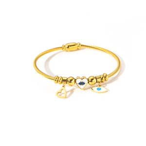 Detail of twisted cable bracelet featuring heart evil eye charm in 18K gold plated steel