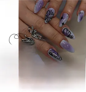 Detailed view of almond-shaped purple gradient press-on nails with 3D butterfly charms