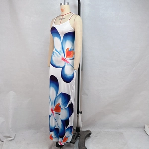 Close-up of vibrant blue and orange floral print on white summer maxi slip dress