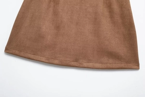 Close-up of brown faux suede hem featuring detailed stitching on the skirt edge