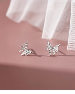 Macro shot of S999 sterling silver lava butterfly earrings with irregular liquid texture