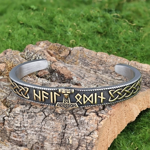 Macro detail of Viking Mjolnir cuff bracelet with Runic symbols on aged tree bark