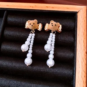 18K gold plated pearl bear earrings with brown flocking and gold bow accents