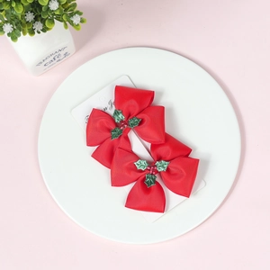 Red Christmas bow hair clips with glitter holly leaves on white card for girls