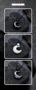 Detailed view of crescent moon pendants in black obsidian and moonstone on volcanic rock