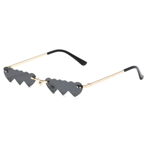 Trendy heart-shaped sunglasses with grey lenses and golden metal frames for parties