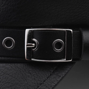 Macro view of black PU leather texture with silver metal buckle and eyelet detail