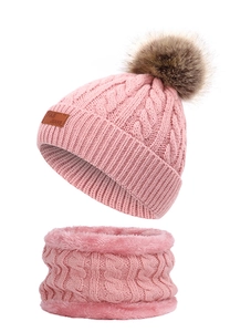 Detailed knit texture and soft lining of pink winter hat and scarf set with pompom