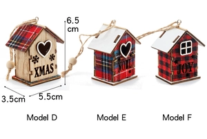 Detail of wooden Christmas house ornaments with plaid roofs and festive engravings
