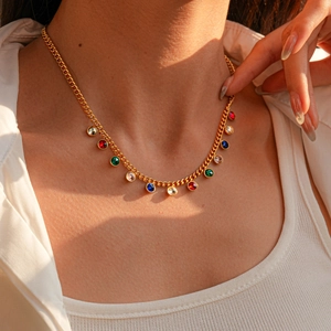 Close-up of gold sweater necklace featuring colorful round and teardrop rhinestones