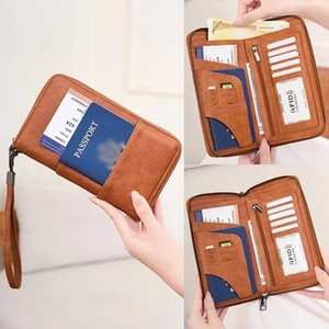 Detail view of RFID blocking passport wallet with brown lychee texture and multi-card slots