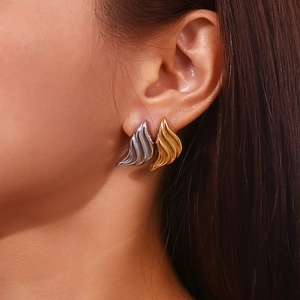 Abstract liquid waterdrop earrings in 18K gold and silver plating shown on a model
