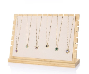 Detail of bamboo jewelry display board with cream velvet lining and 12 side notches