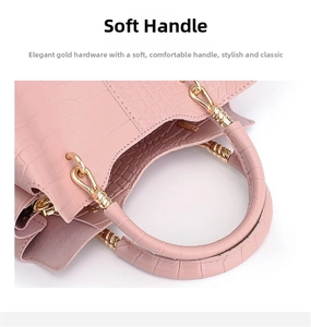 Close-up of pink crocodile texture handbag featuring unique gold spiral metal hardware