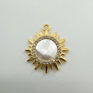 Detailed view of 18K gold plated sun pendant with white shell and sparkling zircons
