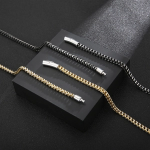 Detail of woven keel chain jewelry in black and two-tone gold-silver finishes