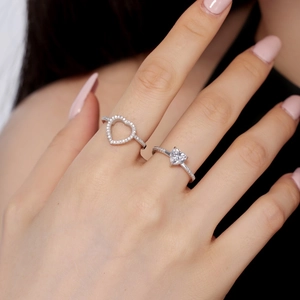 Close-up of S925 sterling silver heart rings with pavé zircon setting on female fingers