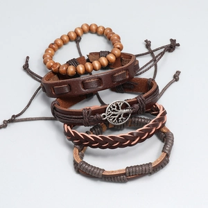 Detail view of 4-piece vintage brown leather bracelet set with silver tree of life charm