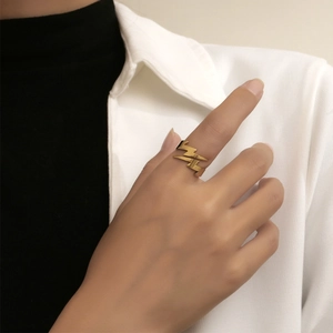 Minimalist golden stainless steel lightning ring for women shown on model's finger