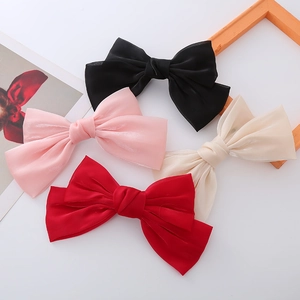 Elegant satin bow hair clips in black, pink, champagne, and red for women's hair styling