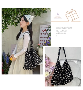 Macro view of canvas tote bag featuring white bow patterns on black fabric