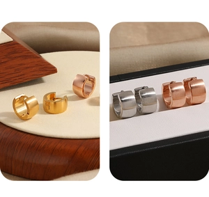 Detail of brushed metal wide hoop earrings in gold, rose gold, and silver finishes