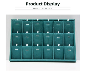 Detail of dark green velvet jewelry tray with 18 compartments for necklace and earring display