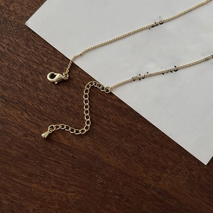 Detail of 18k gold plated lobster clasp and adjustable drop pendant extender chain