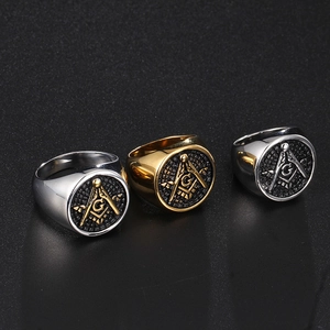 Detailed view of Masonic Square and Compasses engraving on three stainless steel rings