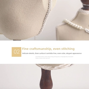 Detail of beige linen portrait necklace stand with premium wood base and woven edges