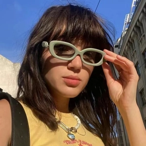 Y2K oval cat-eye sunglasses with thick green frames and dark lenses for women