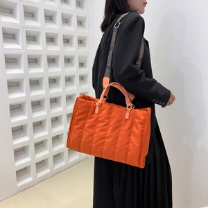 Quilted orange tote bag with jacquard strap for women's casual fashion and commuting