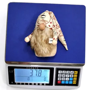 Rudolph coffee gnome plush doll with beard and cup on a scale for weight measurement