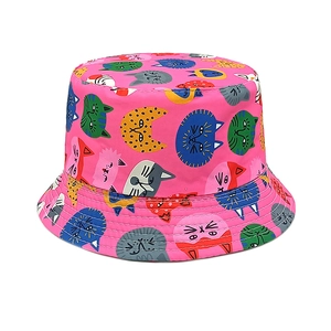 Detail of pink cotton bucket hat featuring colorful cartoon cat prints and reinforced stitching