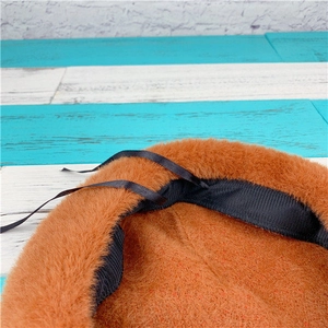 Detail view of the plush beret interior with black ribbed band and adjustable straps