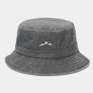 Close-up of mountain peak embroidery on a dark grey washed cotton bucket hat