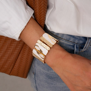 Close-up of retro gold hammered metal and marble texture elastic patchwork bracelet