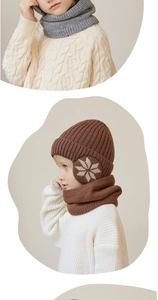 Detail of warm brown knit pom-pom hat and matching fleece-lined neck gaiter for kids