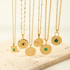 Gold stainless steel evil eye and gemstone necklaces set on a natural stone base