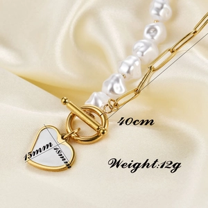 Detail of 15mm heart pendant necklace featuring Baroque pearls and gold OT buckle closure