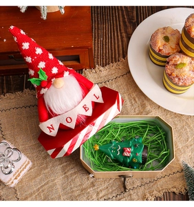 Close-up of festive Christmas Santa doll and NOEL bunting banner with holiday ornaments
