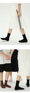 Detail showing elastic ribbed cotton kids socks in black, brown, and white colors