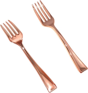 Close-up of two elegant disposable rose gold plastic forks with a metallic finish