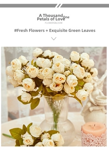 Vintage style artificial cream roses in a ribbed glass vase with elegant decor items