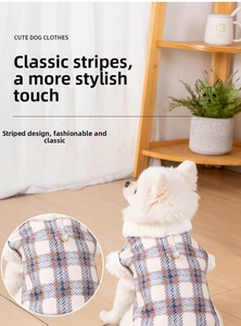 Macro detail of plaid pet vest featuring plush collar and metal D-ring for leash attachment