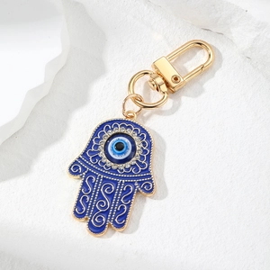 Detail of blue and gold Hamsa keychain with Evil Eye and crystal rhinestones
