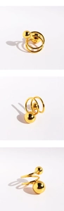 Detailed views of gold spiral wide ring with dual sphere accents from multiple angles